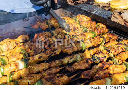 Skewer meat cooking on barbecue, shashlik. Shish kebab on skewer. Chicken BBQ grill. Barbecue grill. Grilled chicken shish kebab. Delicious shish kebab with vegetables. Grilled BBQ pork. Street food Skewer meat cooking on barbecue, shashlik. Shish kebab on skewer. Chicken BBQ grill. Barbecue grill. Grilled chicken shish kebab. Delicious shish kebab with vegetables. Grilled BBQ pork. Street food 142193610