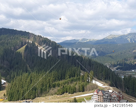 Mountain Ski Resort Surrounded by Snowy Peaks and Evergreen Forest Mountain Ski Resort Surrounded by Snowy Peaks and Evergreen Forest 142195540