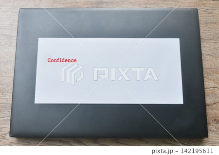 white envelope with red confidence letter arranging on black laptop 142195611