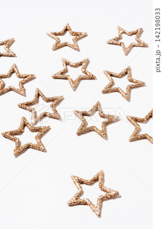 Golden Glitter Stars on White Background Golden Glitter Stars on White Background 142198033