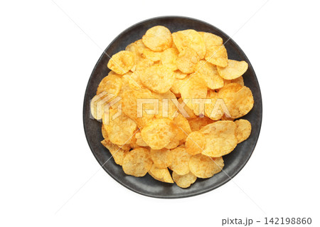 Potato chips on plate isolated on white background. 142198860