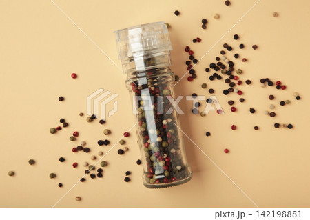 Plastic pepper mill on beige background. Space for text 142198881