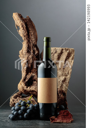 Red wine with stone, dried snags, and blue grapes. Red wine with stone, dried snags, and blue grapes. 142198993