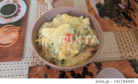 Homemade potato and shrimp gratin with fresh herbs in a small bowl Homemade potato and shrimp gratin with fresh herbs in a small bowl 142199485