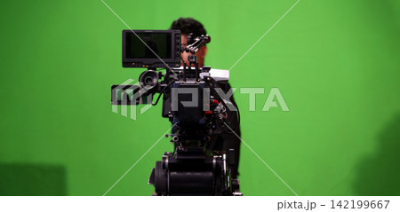 Behind the scenes. BTS of TV commercial movie film or video shooting production which pro camera crew setting up on green screen for chroma key technique in studio. Greenscreen background shooting set Behind the scenes. BTS of TV commercial movie film or video shooting production which pro camera crew setting up on green screen for chroma key technique in studio. Greenscreen background shooting set 142199667