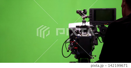Behind the scenes. BTS of TV commercial movie film or video shooting production which pro camera crew setting up on green screen for chroma key technique in studio. Greenscreen background shooting set Behind the scenes. BTS of TV commercial movie film or video shooting production which pro camera crew setting up on green screen for chroma key technique in studio. Greenscreen background shooting set 142199671