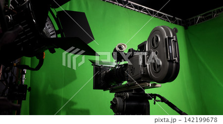 Behind the scenes. BTS of TV commercial movie film or video shooting production which pro camera crew setting up on green screen for chroma key technique in studio. Greenscreen background shooting set 142199678