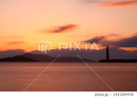 Seascape at sunshine. Lighthouse and sailings on the coast. Seaside town of Turgutreis and spectacular sunshine Seascape at sunshine. Lighthouse and sailings on the coast. Seaside town of Turgutreis and spectacular sunshine 142200456