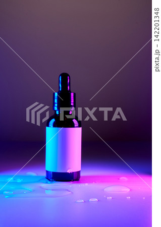Skincare serum dropper bottle in neon light Skincare serum dropper bottle in neon light 142201348