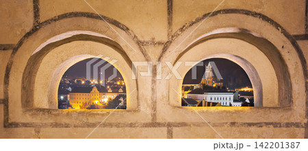Cesky Krumlov skyline framed by medieval arched windows Cesky Krumlov skyline framed by medieval arched windows 142201387