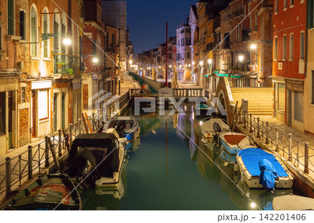 Venetian Canal with Bridges and Reflections Before Sunrise in Venice, Italy Venetian Canal with Bridges and Reflections Before Sunrise in Venice, Italy 142201406