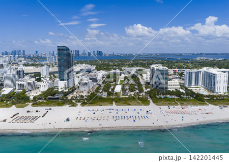 Miami beach with turquoise waters. Aerial view of sandy coastline and waves. Tropical Miami Beach scene with sandy beach. Oceanfront of South Miami. 142201445