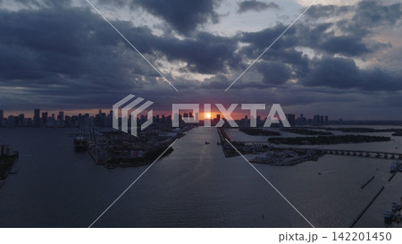 Miami skyscrapers above the coastline at sunset. Miamis coastal landscape from above. Top view of Miami shoreline. Aerial view of Miami beach and ocean. Miami coastline on night. Miami skyscrapers above the coastline at sunset. Miamis coastal landscape from above. Top view of Miami shoreline. Aerial view of Miami beach and ocean. Miami coastline on night. 142201450
