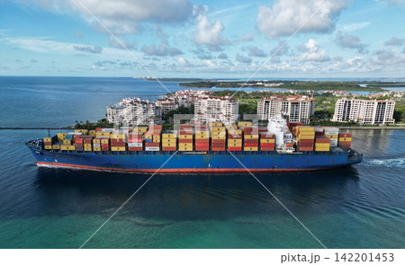 Miami, Florida, USA - June 07, 2024: Freight container loaded on cargo vessel in Miami. Aerial view cargo ship leaving port of Miami. Container ship. Cargo ship with container in Miami, aerial view Miami, Florida, USA - June 07, 2024: Freight container loaded on cargo vessel in Miami. Aerial view cargo ship leaving port of Miami. Container ship. Cargo ship with container in Miami, aerial view 142201453
