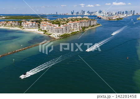 Aerial view of boats on turquoise waters in Miami. Yacht retreat in Miami. Cityscape with sailing vessels in Miami. Aerial view of boats on turquoise waters in Miami. Yacht retreat in Miami. Cityscape with sailing vessels in Miami. 142201458