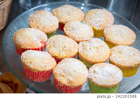 muffins displayed on a plate in a kitchen or dining area with a top-down view, featuring yellow and red colors and a clean background for in food photography and baking. muffins displayed on a plate in a kitchen or dining area with a top-down view, featuring yellow and red colors and a clean background for in food photography and baking. 142201508