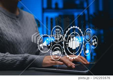 Digital Marketing and Target Audience Strategy Concept. Person using laptop with marketing icons like target audience, email, SEO, social media, representing market planning and customer engagement. 142201676