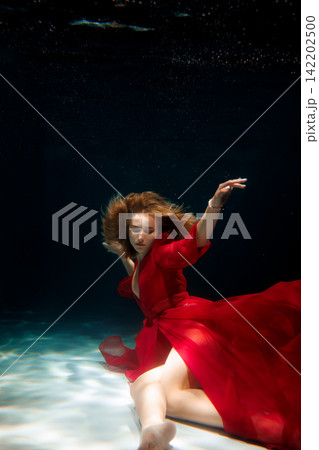 Vibrant underwater ballet with lively movements and colorful lighting Vibrant underwater ballet with lively movements and colorful lighting 142202500