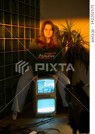 Reflective young lady enjoying peaceful indoor environment Reflective young lady enjoying peaceful indoor environment 142202575