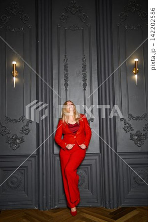 Ambitious female in red blazer exudes modern professional confidence Ambitious female in red blazer exudes modern professional confidence 142202586