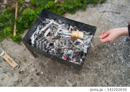 Barbecue setting with glowing embers and casual atmosphere 142202630