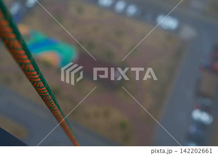 Safety rope anchored on building exterior, maintenance setup Safety rope anchored on building exterior, maintenance setup 142202661