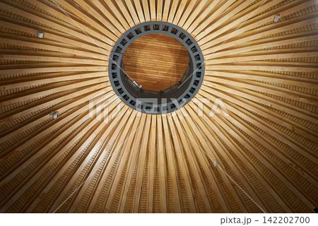 Circular timber ceiling featuring central skylight and warm glow Circular timber ceiling featuring central skylight and warm glow 142202700