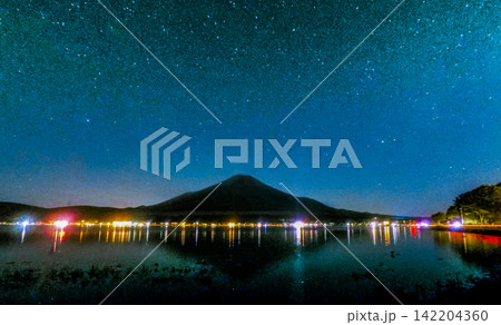 Mount Fuji Silhouette Beneath the Milky Way and Lakeside City Lights Mount Fuji Silhouette Beneath the Milky Way and Lakeside City Lights 142204360