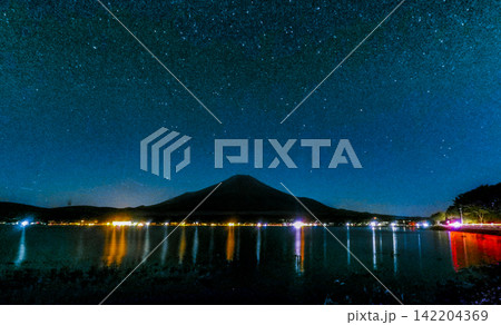 Mount Fuji Silhouette Beneath the Milky Way and Colorful Lake Reflections Mount Fuji Silhouette Beneath the Milky Way and Colorful Lake Reflections 142204369