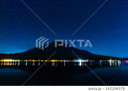 Mount Fuji Centered Beneath a Wide Blue Starry Sky With Lake Reflections Mount Fuji Centered Beneath a Wide Blue Starry Sky With Lake Reflections 142204378