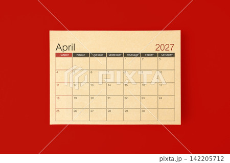 April 2027 desk calendar made from brown paper page on red background. 142205712