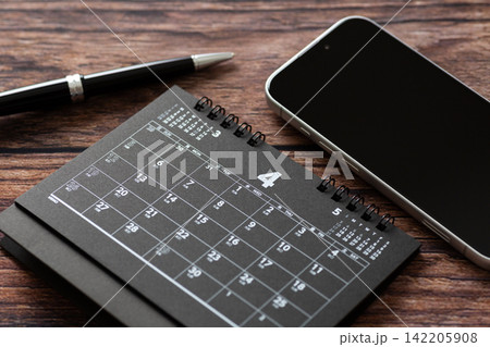 4月の黒いカレンダーとスマホ 4月の黒いカレンダーとスマホ 142205908