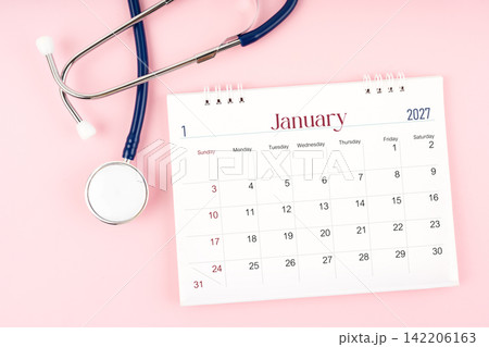 Blank January 2027 desk calendar and stethoscope, Medical appointment schedule to check up. Blank January 2027 desk calendar and stethoscope, Medical appointment schedule to check up. 142206163