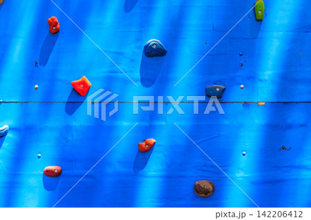 Background of the climbing wall with toe and hand hold studs Background of the climbing wall with toe and hand hold studs 142206412