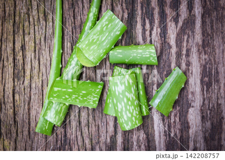 aloe vera plant slice on rustic wood background - Close up of fresh aloe vera leaf with gel natural herbs and herbal medicines aloe vera plant slice on rustic wood background - Close up of fresh aloe vera leaf with gel natural herbs and herbal medicines 142208757