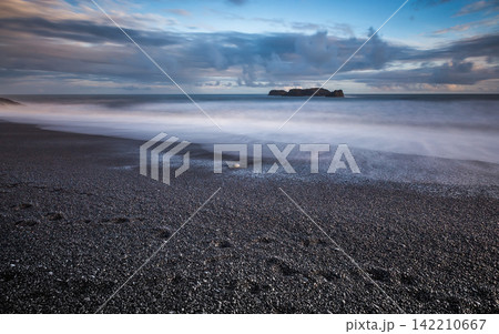 Stormy Ocean Seascape with Black Pebble Beach and Long Exposure Waves Stormy Ocean Seascape with Black Pebble Beach and Long Exposure Waves 142210667