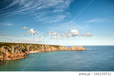Rocky Coastline with Blue Ocean, Cliffs, and Cloudy Sky Rocky Coastline with Blue Ocean, Cliffs, and Cloudy Sky 142210712