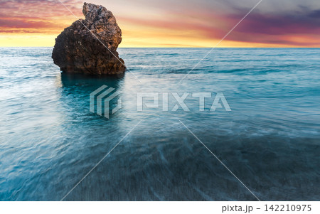 Ocean Rock at Sunset with Calm Turquoise Water Ocean Rock at Sunset with Calm Turquoise Water 142210975