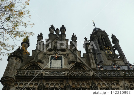 Gothic Clock Tower on Historic Stone Building Facade Gothic Clock Tower on Historic Stone Building Facade 142210992