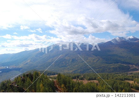 Snow Capped Mountain Landscape with Forest Valley and Cloudy Sky Snow Capped Mountain Landscape with Forest Valley and Cloudy Sky 142211001