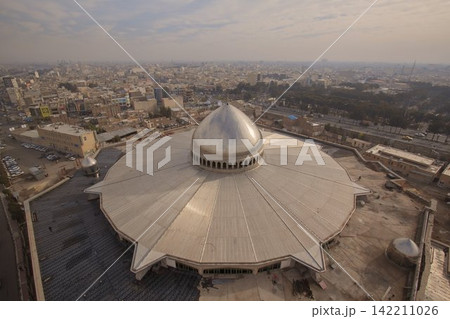 Aerial View of Silver Mosque Dome Over Hazy Middle Eastern City 142211026