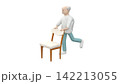 Elderly male doing exercises for hamstrings using a chair for stability 142213055