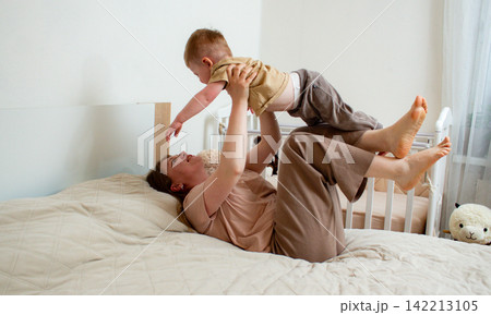 Cute little boy hug cuddle with smiling mother. Intimate moment between mom and son. Kissing show love. Small boy embrace happy millennial mom 142213105