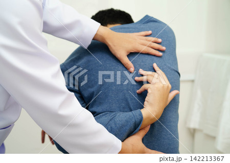 Physical therapy, Asian therapist doctor treat perform pain therapy in hospital. Physical therapy, Asian therapist doctor treat perform pain therapy in hospital. 142213367