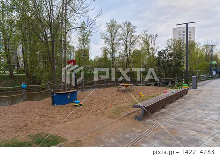 Deserted park scene. Tranquil neighborhood with playground and nature 142214283