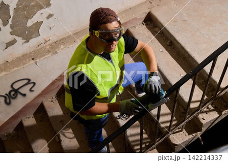 Authentic scene of worker cleaning and restoring urban staircase Authentic scene of worker cleaning and restoring urban staircase 142214337
