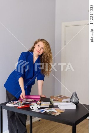 Caucasian workshop instructor preparing craft materials 142214338