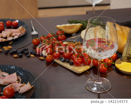 Charming evening scene with sparkling beverage and food Charming evening scene with sparkling beverage and food 142214373