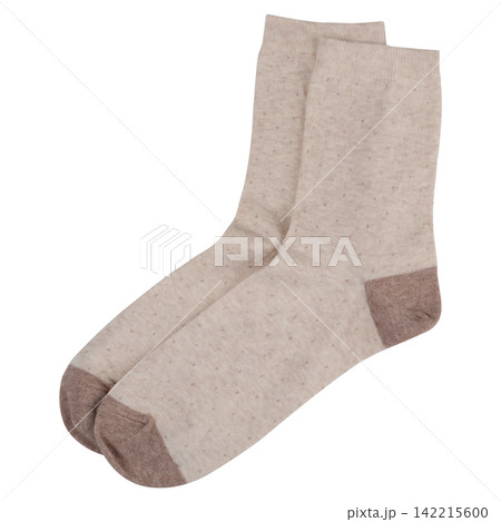 Pair of beige polka dot cotton socks isolated on white background. Casual knit footwear with brown heel and toe Pair of beige polka dot cotton socks isolated on white background. Casual knit footwear with brown heel and toe 142215600