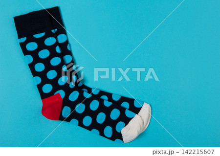Pair of blue polka dot socks on bright blue background with copy space. Funny colorful casual hosiery top view Pair of blue polka dot socks on bright blue background with copy space. Funny colorful casual hosiery top view 142215607